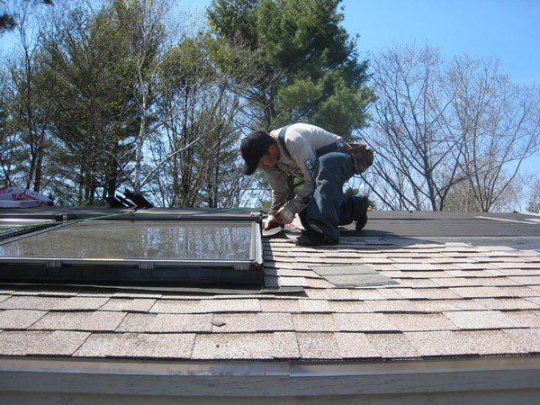 Charlie on a Boston roof, flashing a skylight